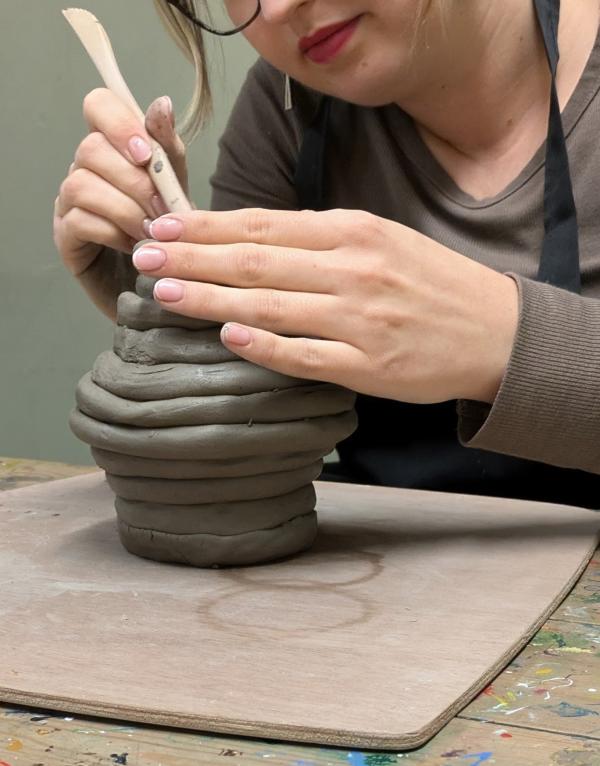 Pottery Course Leeds. Woman making handmade coil pot from clay.