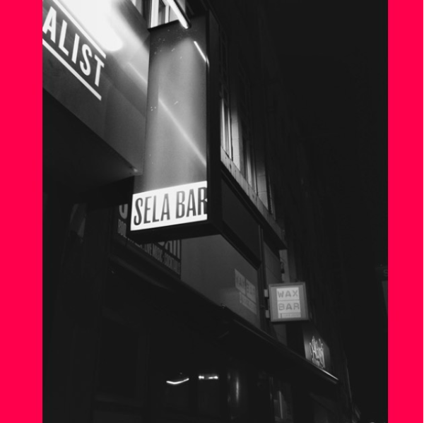 Black & white photograph of outside light box reading 'SELA BAR'