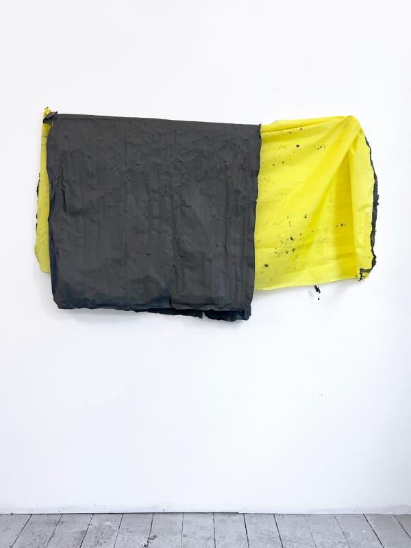 Black and yellow artwork on a gallery wall.