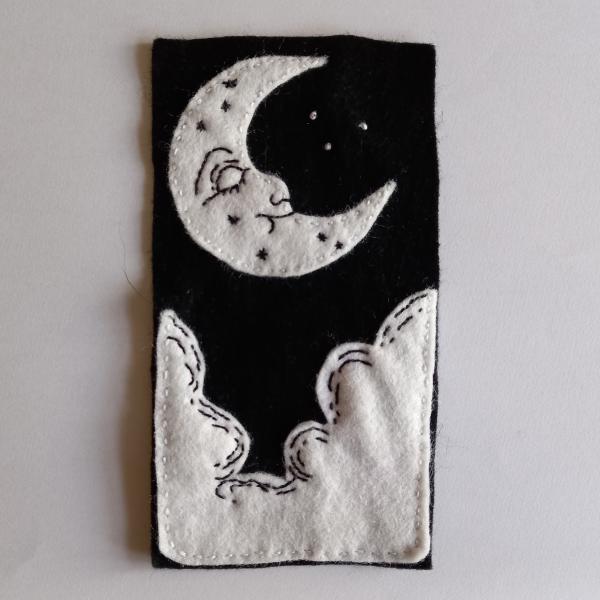 A black and white patch with a moon and clouds