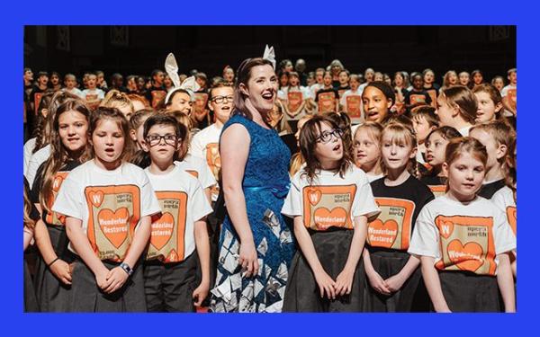 A group of children and a woman singing in Opera North Wonderland Restored t-shirts