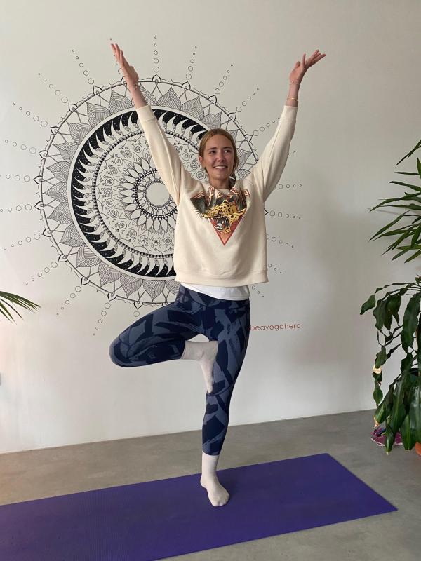 Yoga Teacher in yoga pose smiling