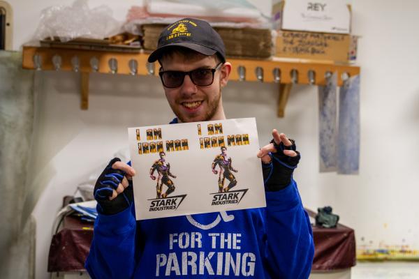 Alfie Fox poses with a print he made during the Prints of Possibility project