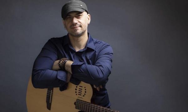 BD Lenz sitting with guitar