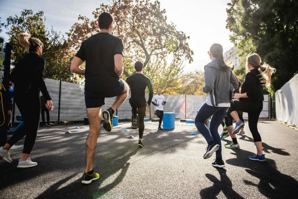 A group of people running on the spot warming up for a boot camp session