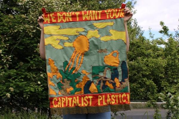 Person holding banner outside