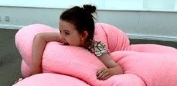You person in the middle of a pink fluffy scultpure
