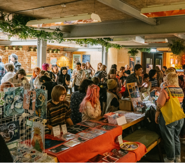 Photograph of student makers selling their artwork
