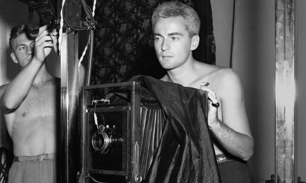 Black and White Photo of George Platt Lynes taking a photo topless as another man takes a picture of him, also topless.