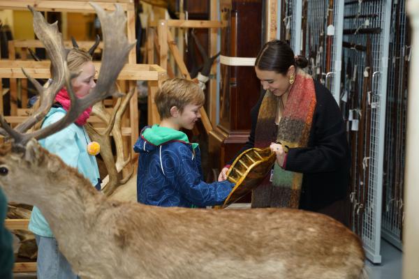 Children touch a turtle shell as part of their tour of Leeds Discovery Centre