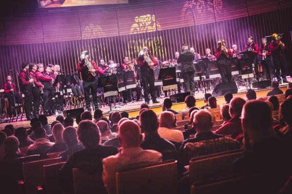A brass band performing on a stage. 