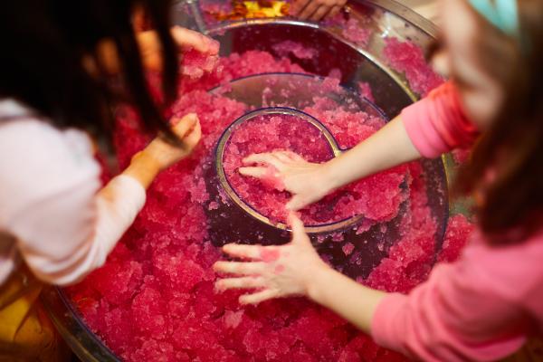 Children playing with a red goo activity