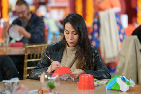 A photo of a woman creating a mask