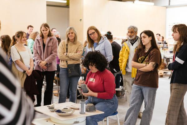 Pottery demonstration at Sunken Studio with visitors watching ceramic decorating process