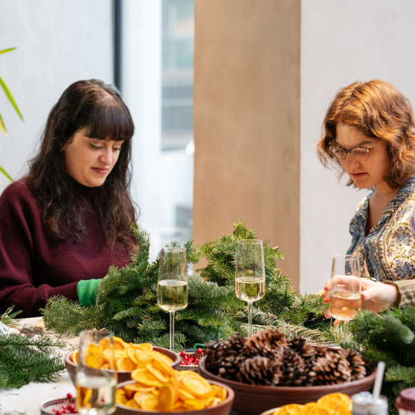 Two woman doing a wreath making workshop.