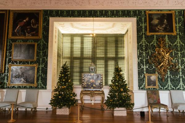 Photograph of inside of Temple Newsam with two small decorated Christmas trees