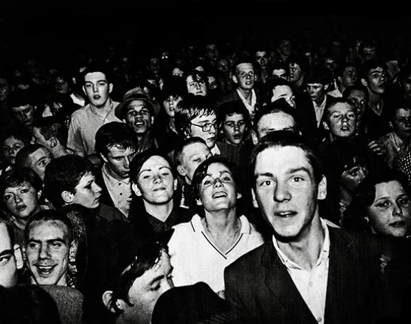 Black and white image of a young crowd of fans
