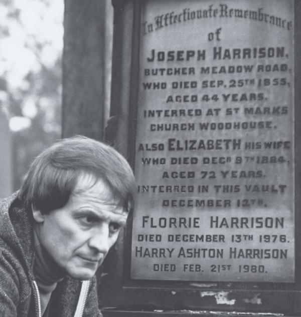 Tony Harrison in front of a gravestone