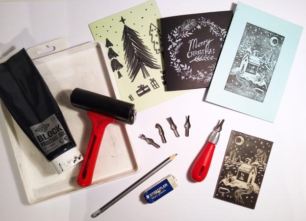 Various print making equipment, roller, ink, lino cutting tool, papers, inks and a few Christmas card ideas.