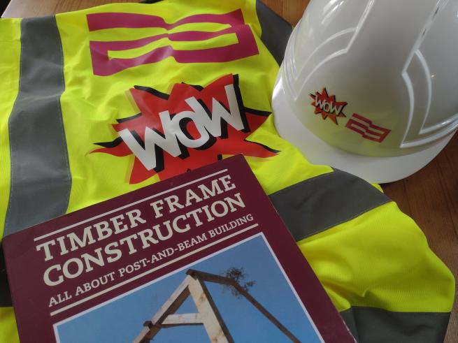 a book a hi vis jacket and a hard hat