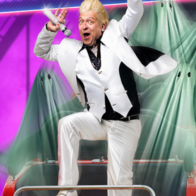 Clinton Baptiste is riding a roller coaster filled with ghosts. He's wearing an 80s suit with big hair.