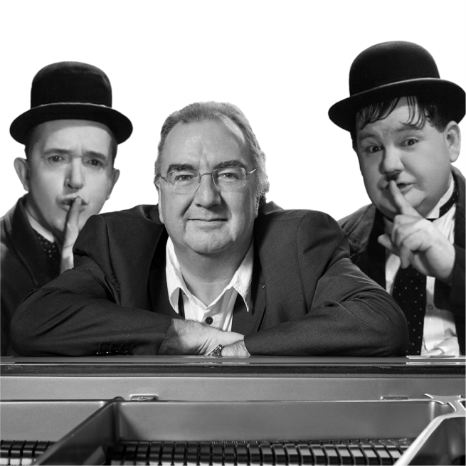 Neil Brand leaning against a piano with Laurel and Hardy by his side. 
