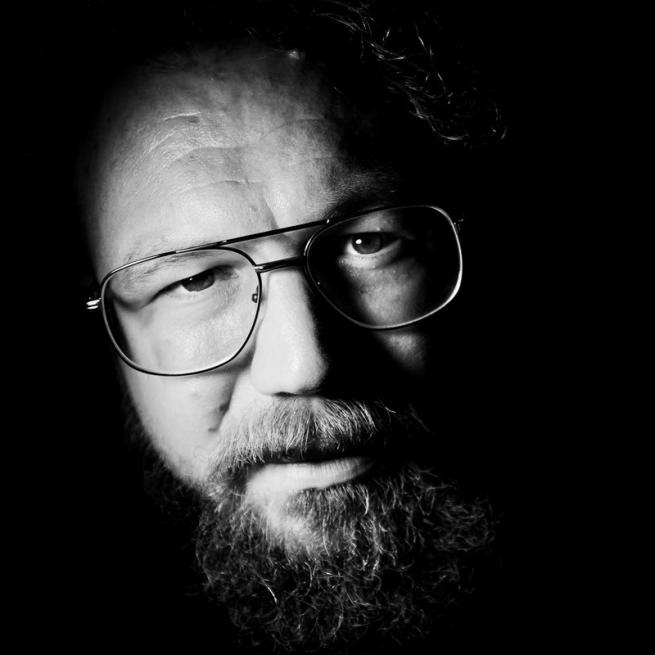 Portrait of Ben against a black backdrop