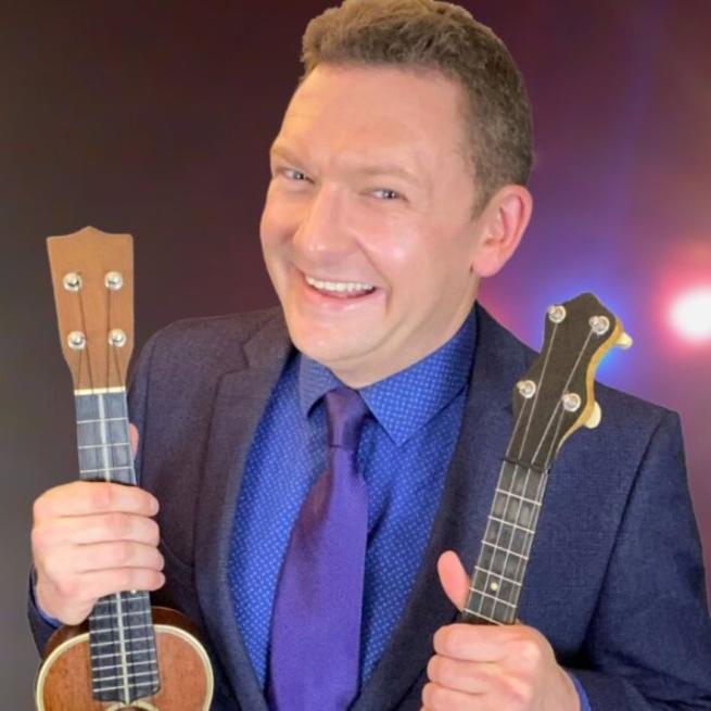Andy Eastwood poses with instruments against a soft focused background.