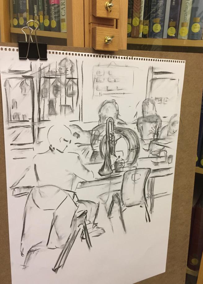 Charcoal sketch of people sat at a table