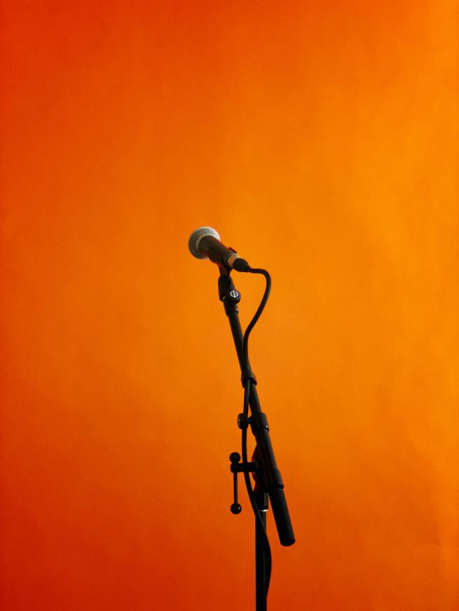 a microphone against an orange background
