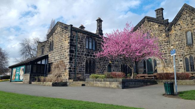 A picture of a house with a tree outside. 