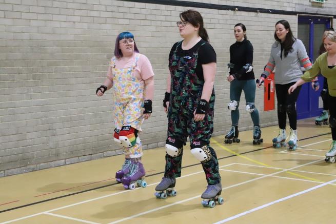 people skating in a sports hall