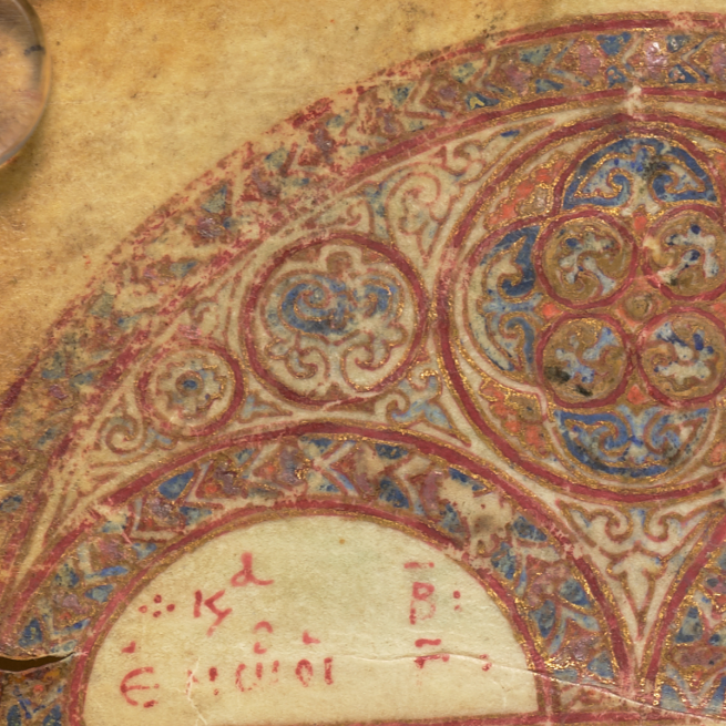 Close up of an illustrated semicircle with floral designs in reds and blues from an old manuscript
