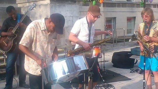 Dudley Nesbitt playing steel pans with his band