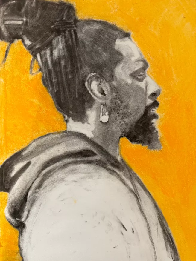 A side profile view of a charcoal drawing of a man with a yellow background
