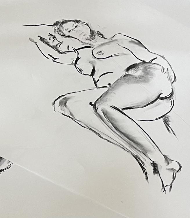 Graphite drawing of female nude model lying on her side