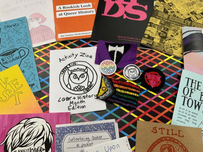 Colourful selection of LGBT+ themed zines and patches
