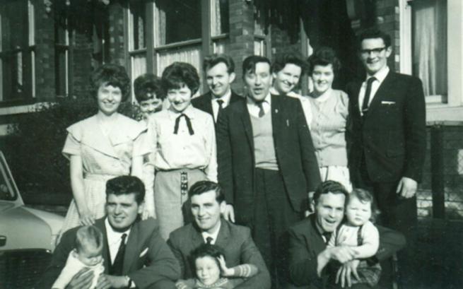 a black and white photograph of a family group
