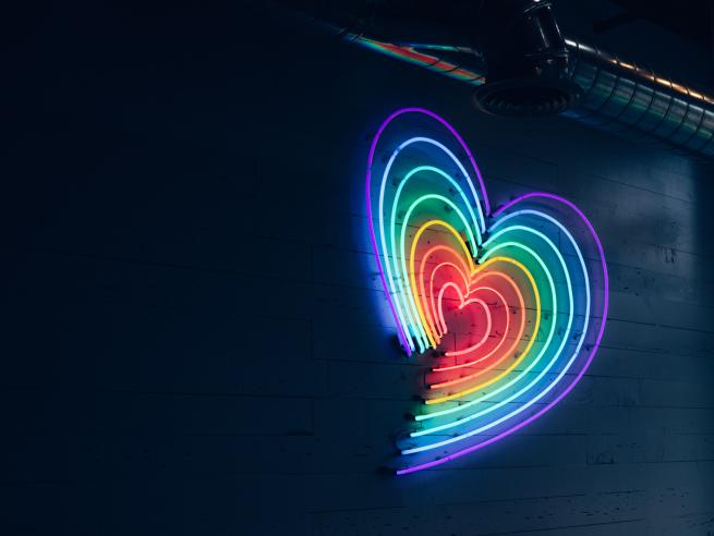A rainbow heart in neon lights