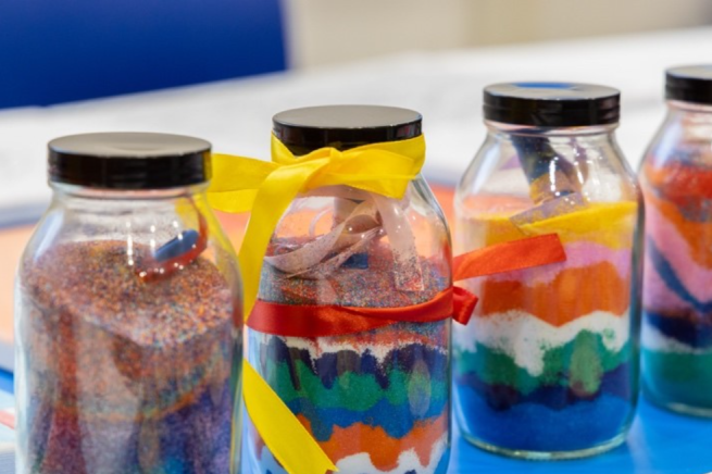Clear jars filled with colourful, layered sand