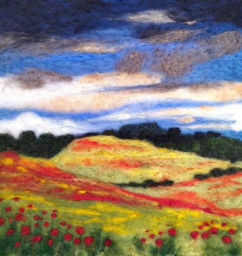 A needle felted landscape by artist Janine Jacques of lush colourful countryside, hills and poppies