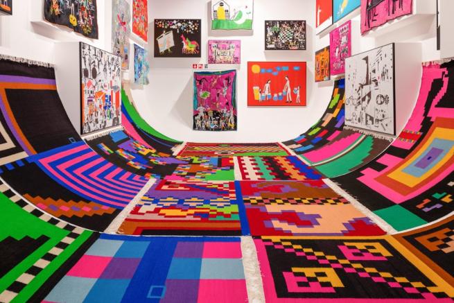 a large room filled with colourful artworks of all shapes and sizes 