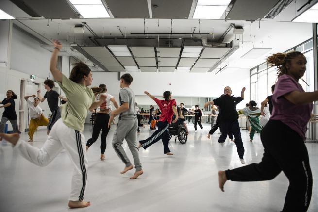 Image of NYDC dancers freely moving around a dance studio space