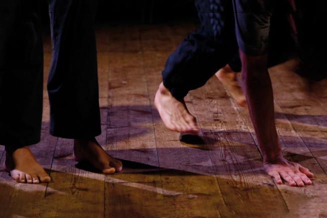 Close ups of feet and hands as two people dancing
