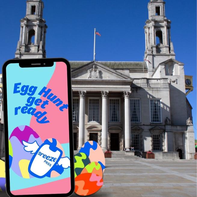 mobile phone with eggs in front of iconic Leeds building