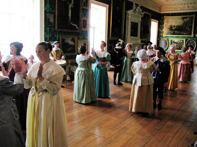 Costumed dancers in the Picture Gallery at Temple Newsam