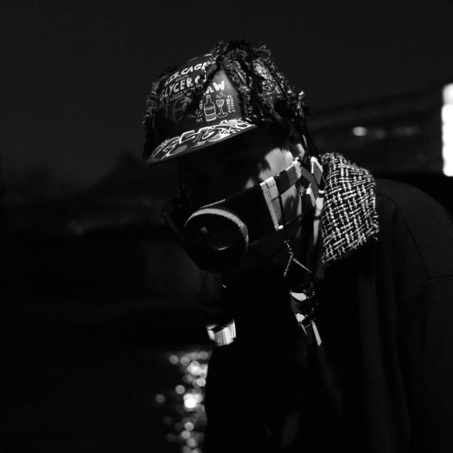 Album cover for Kyra by Herbie Hopkins, who is here wearing a hat and gas mask, in an intentionally dark photo