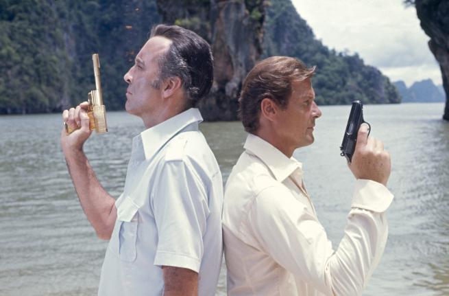 A still from The Man With The Golden Gun featuring Scaramanga and James Bond played by Christopher Lee and Roger Moore respectively.