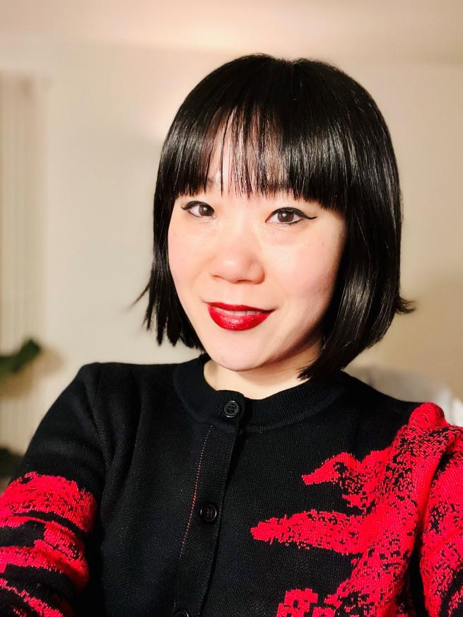 Catherine Hua Xiang, a female Chinese professional wearing red and black