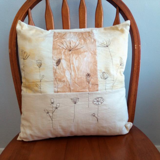 A cushion featuring free machine embroidery designs